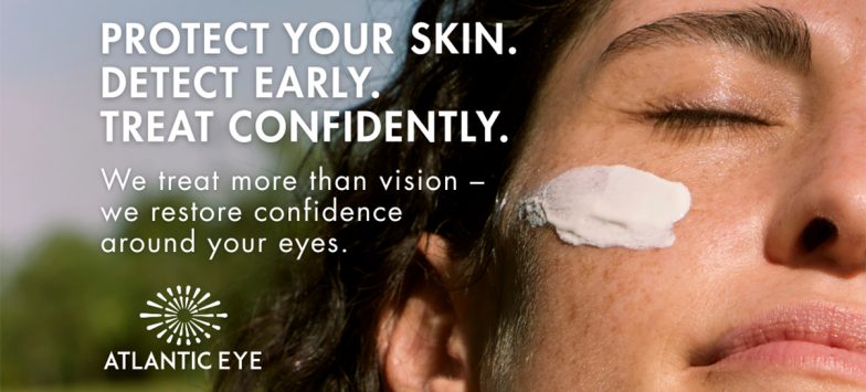 View of a woman's face with eyes closed showing sunblock skin cream under her eye area.